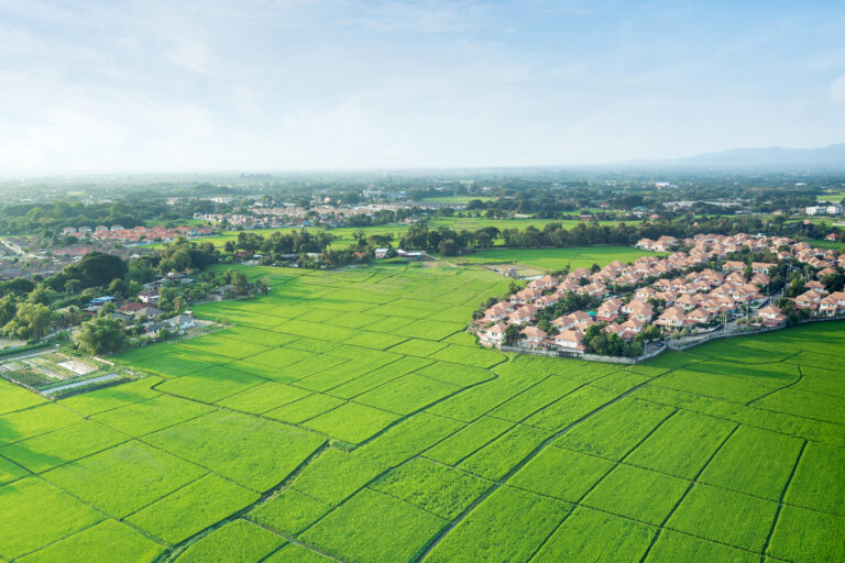 Landscape of green field and house building in aerial view in Chiang Mai of Thailand